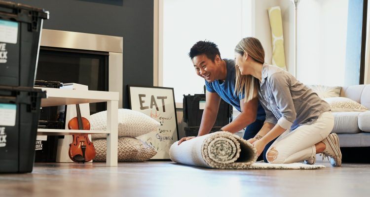 Two people packing up a living room